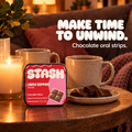 Red and pink Libido Support chocolate tin beside candles, mugs and chocolate