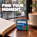 Navy Mushroom Focus Strips tin beside a book and coffee in a cafe