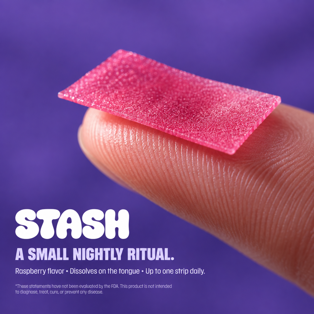 Close-up of a raspberry-colored oral strip on a fingertip